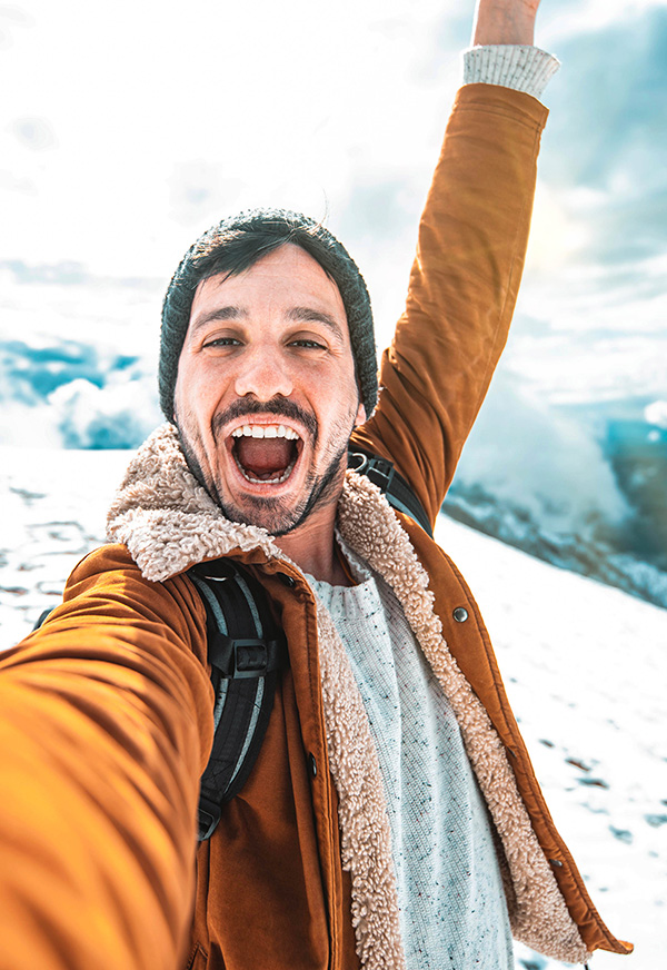 Man taking a selfie on a snowy mountain.